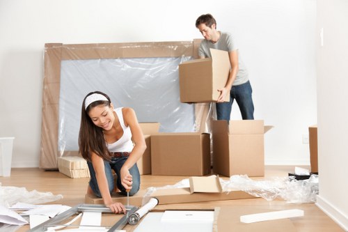 Packing boxes and wrapping fragile items in a West Kensington home