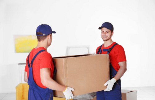 Removal team planning a home move on a West Kensington street