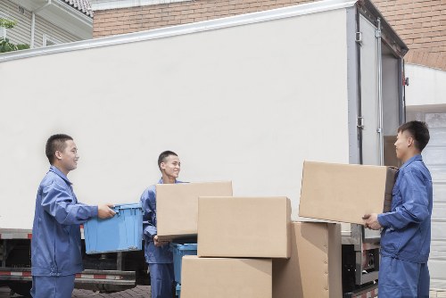 Local moving team handling furniture near West Kensington flats
