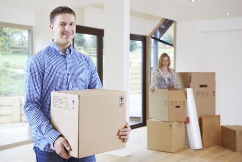 Packed removal boxes and furniture being loaded into a van