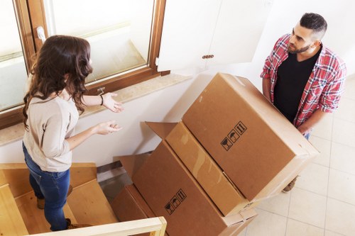 Furniture and boxes being transported by moving truck in West Kensington
