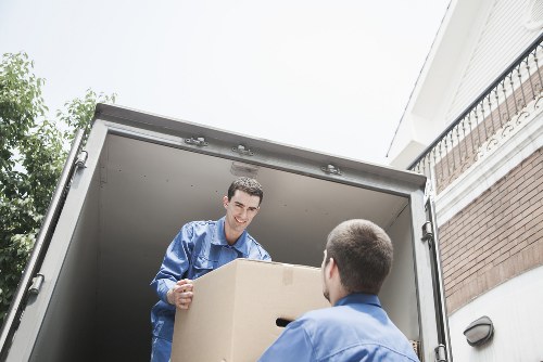 Movers handling desks and office equipment carefully