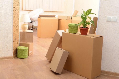 Professional movers carrying furniture near West Kensington flats