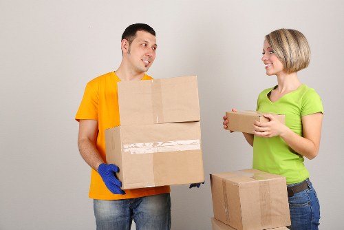 Packed moving boxes and furniture prepared for a West Kensington home relocation