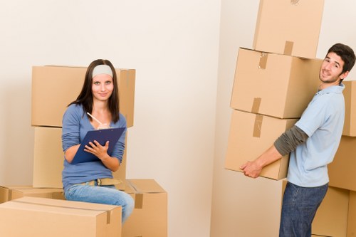 Moving helper carrying boxes during a residential relocation